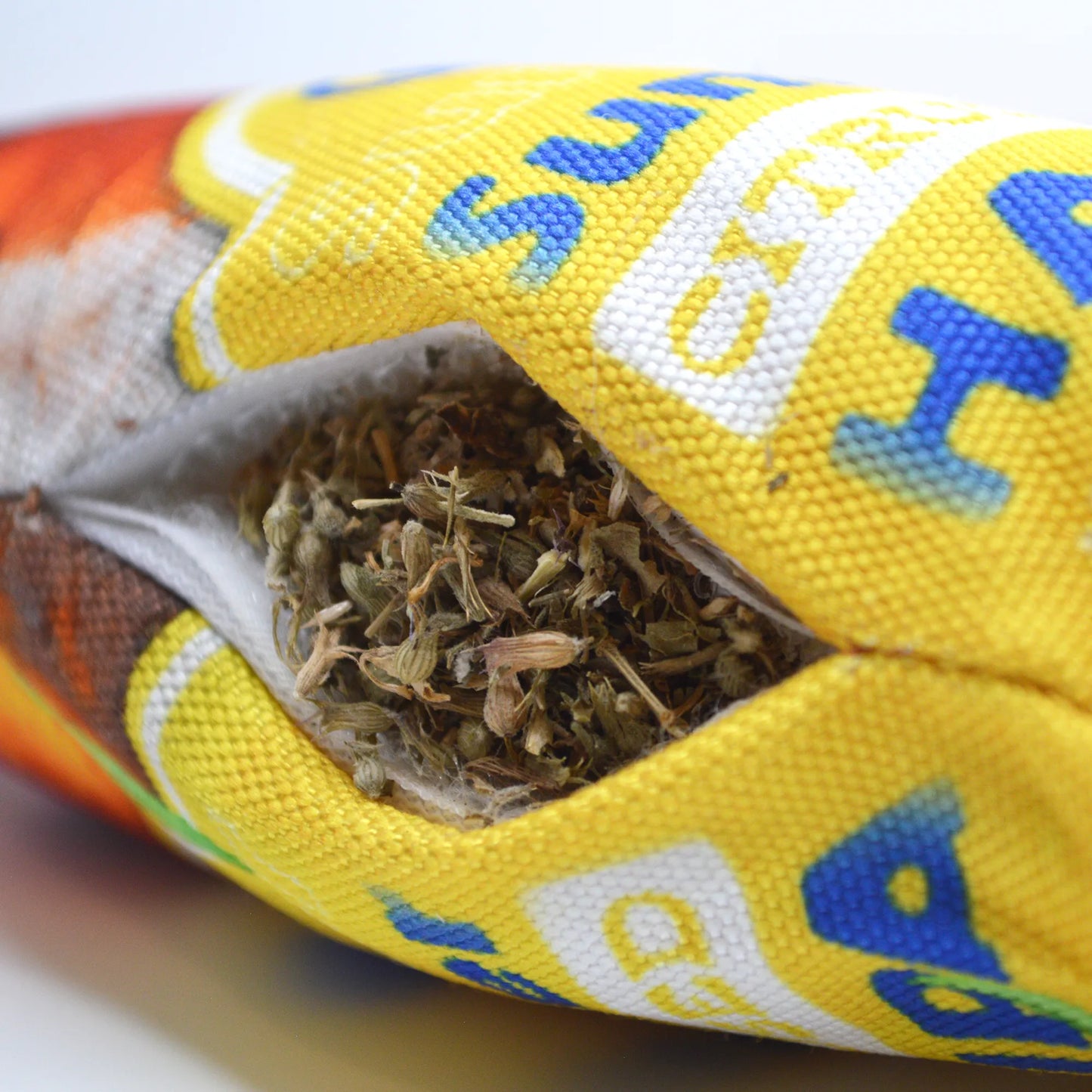 Close-up of the Hazy IPA toy’s refillable pocket, showing catnip securely packed inside the fabric.